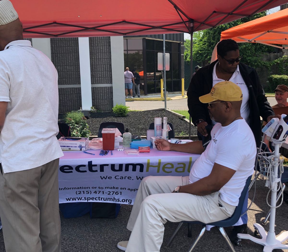 Spectrum staff talk with a guest at their table
