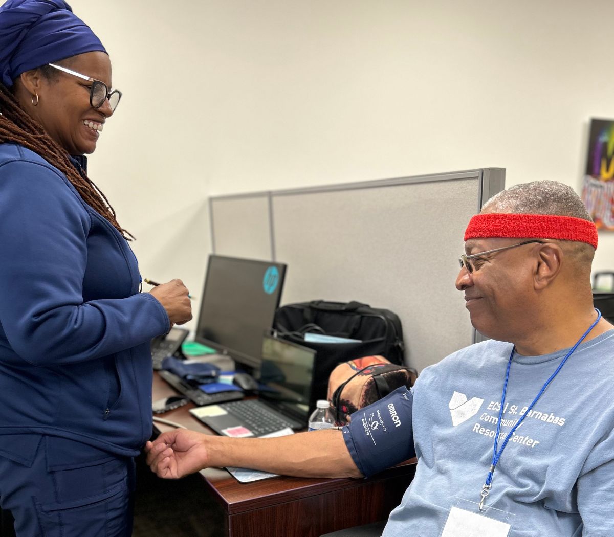A Spectrum staff member checks a man’s blood pressure at Fall Fest