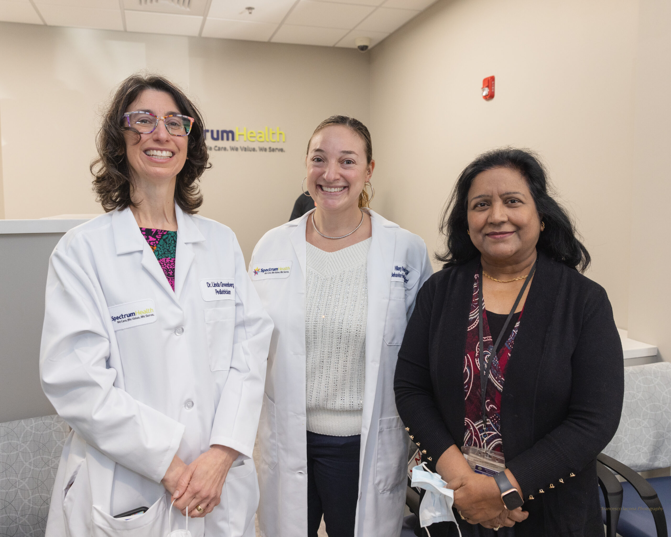 Three Spectrum team members smile in the new center
