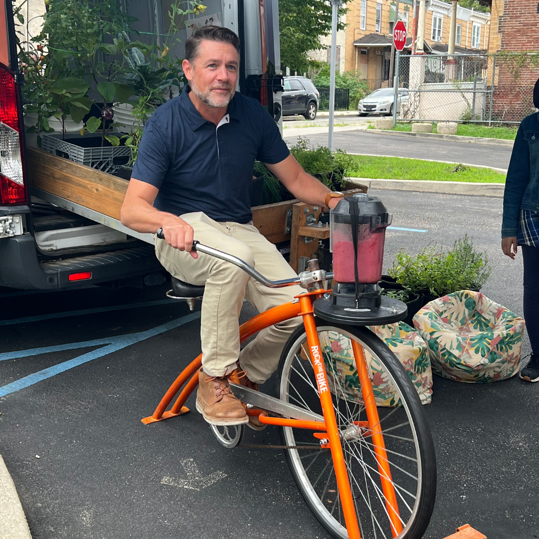 A man pedals the smoothie bike