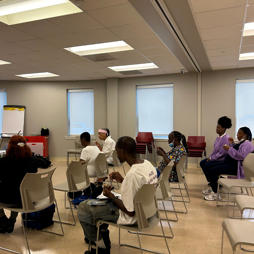 Guests sit in a room during a cooking demonstration