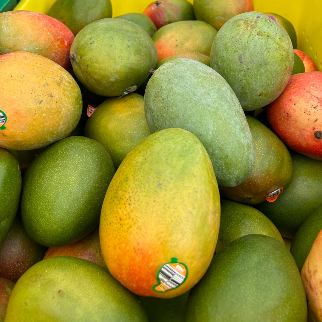 A pile of fresh mangoes