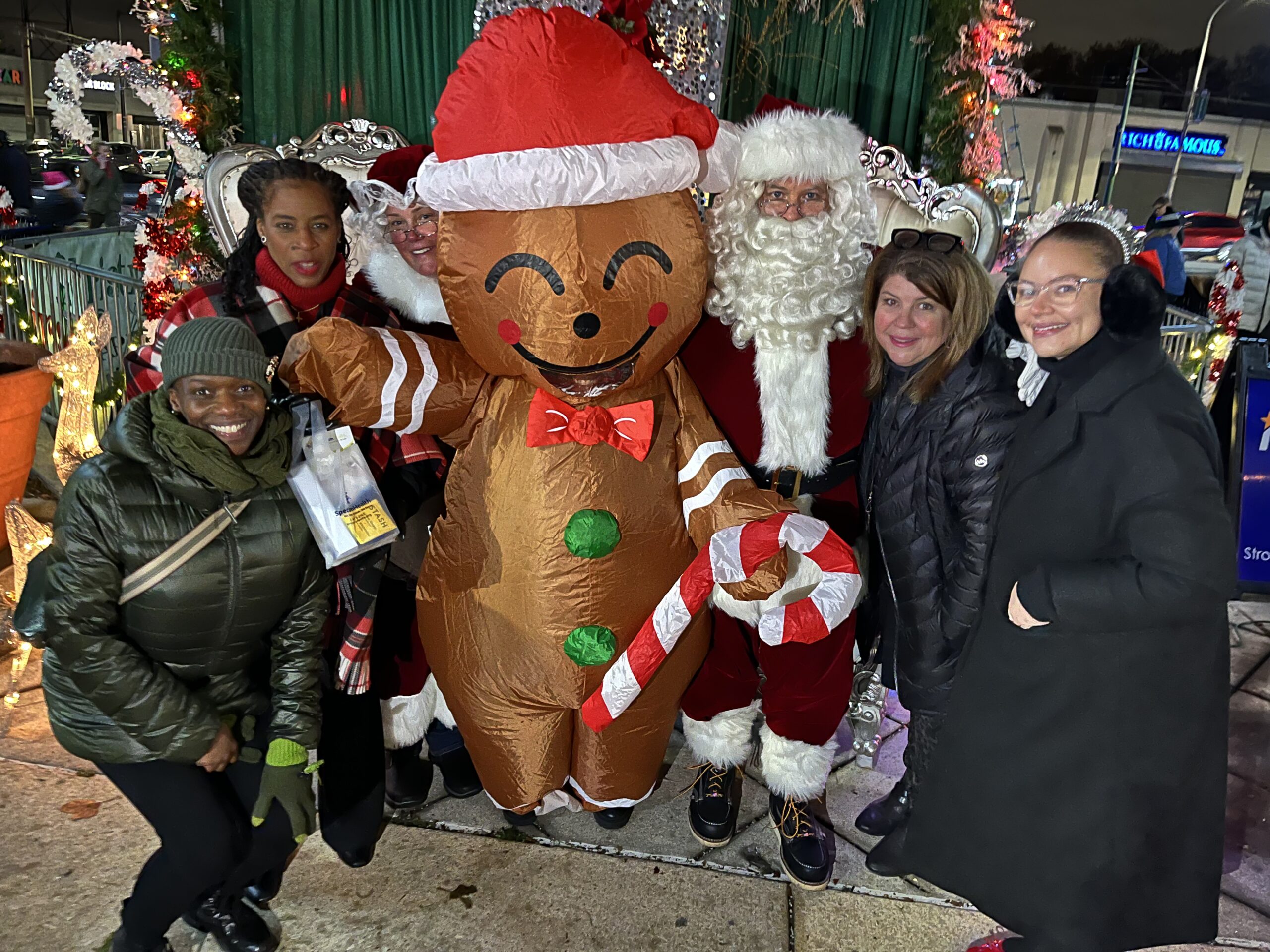 Guests pose with Santa and the gingerbread man