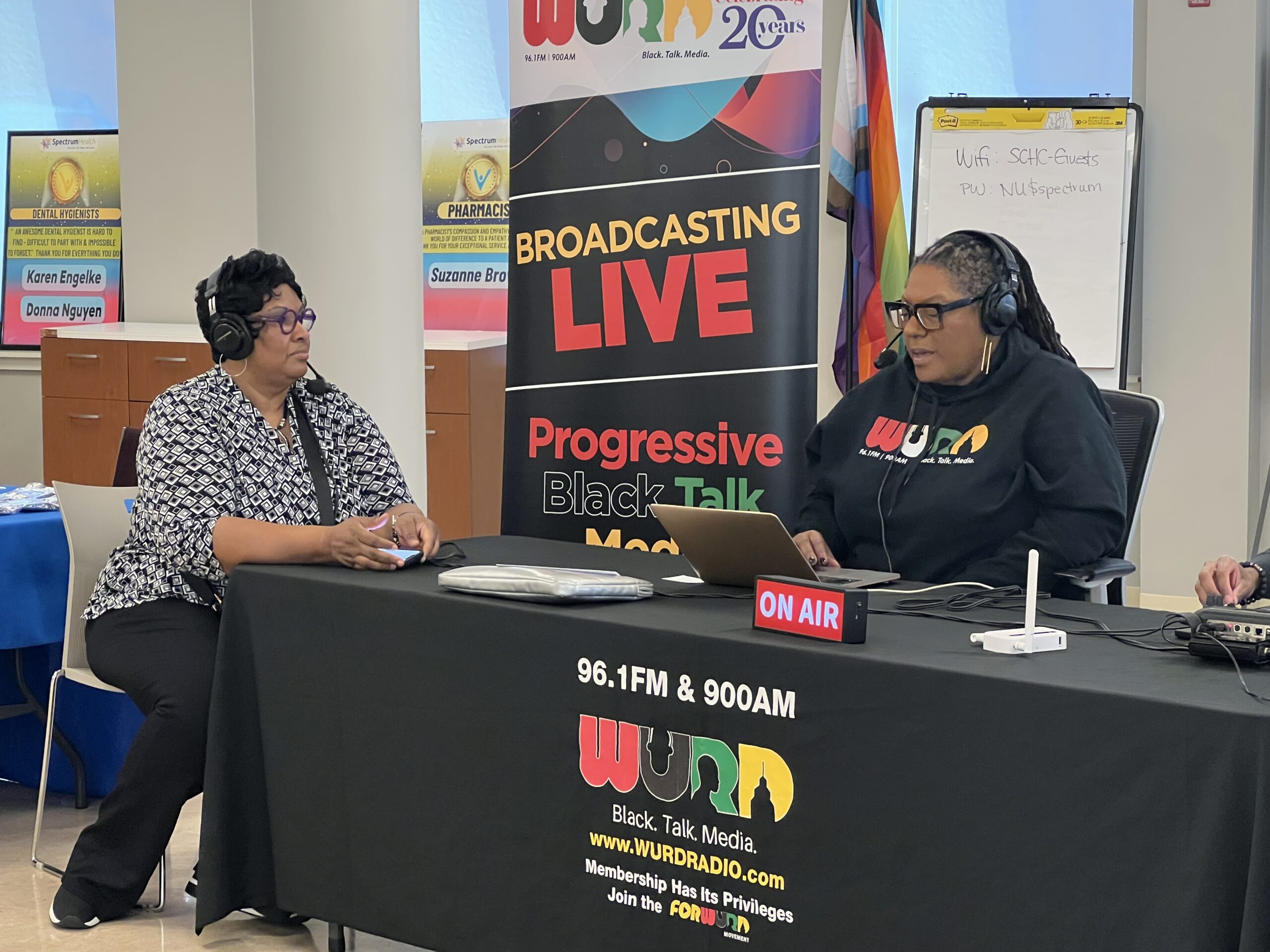 Two guests are interviewed at the WURD radio table