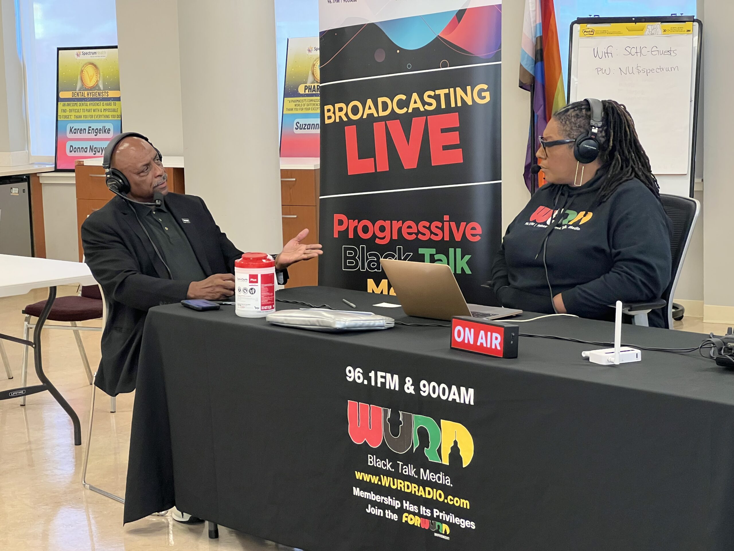 Two guests talk on air at the WURD table
