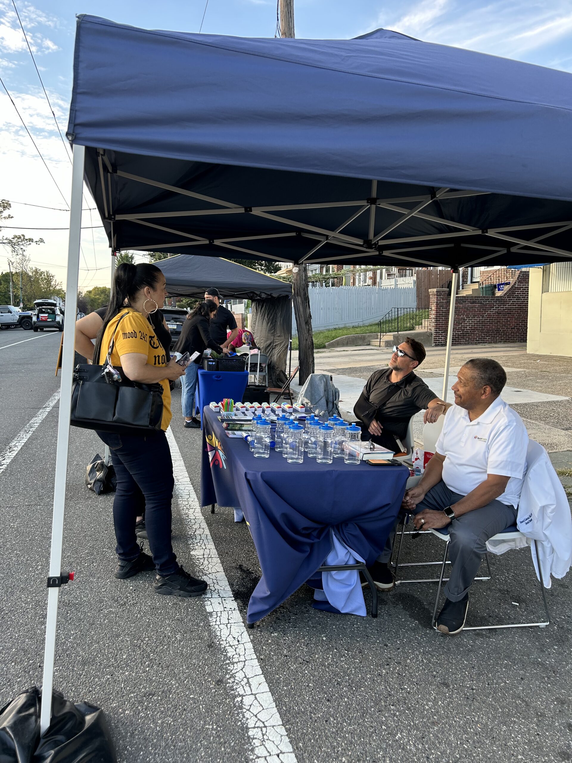 Spectrum staff at their table under a tent