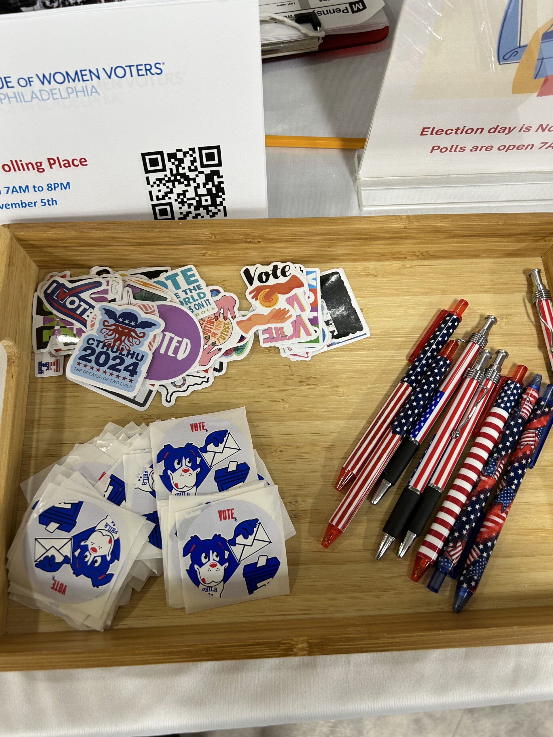 Voter registration flyers, stickers and flag pens on a table