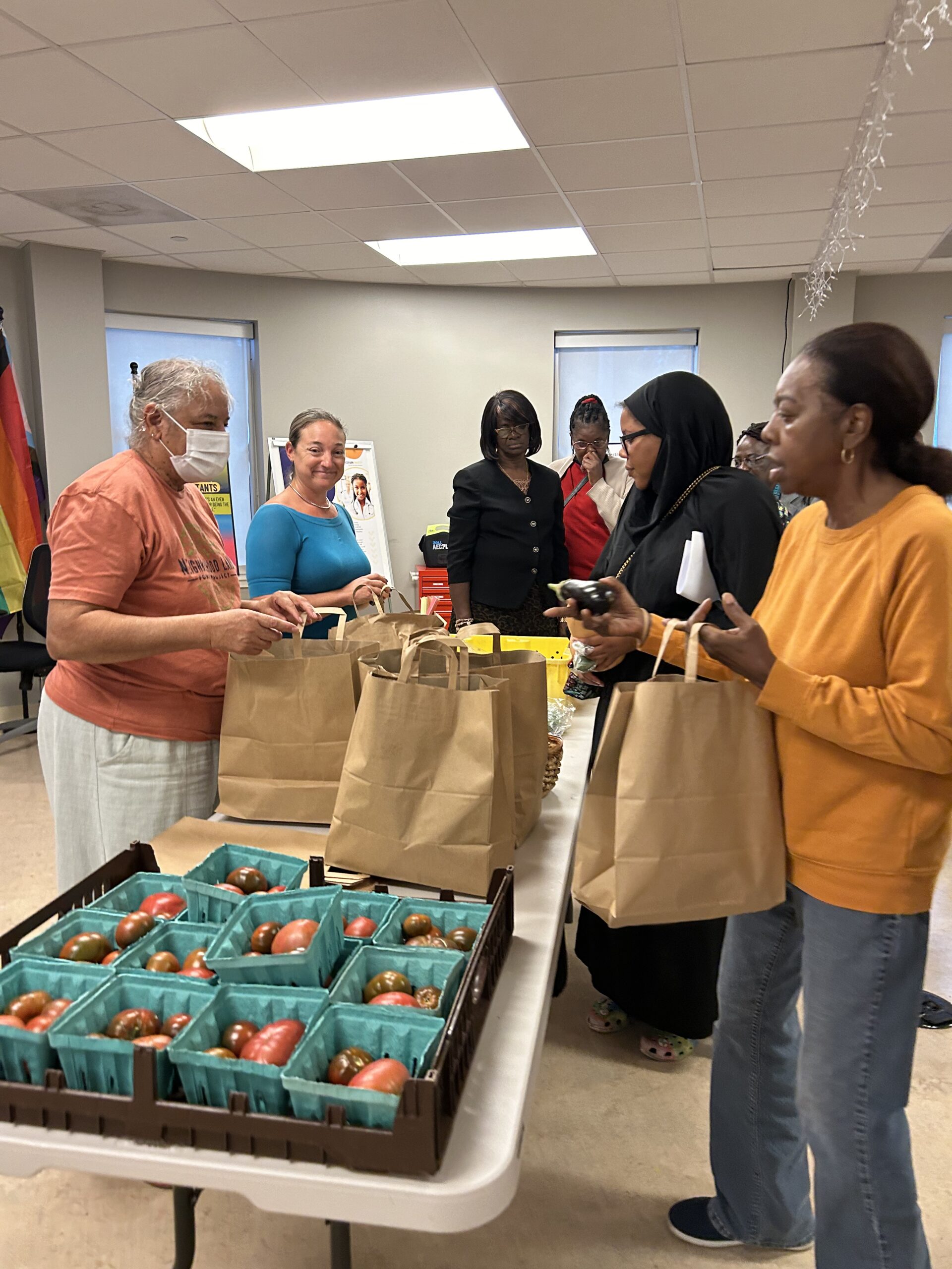 Guests line up for bags of fresh fruit and vegetables