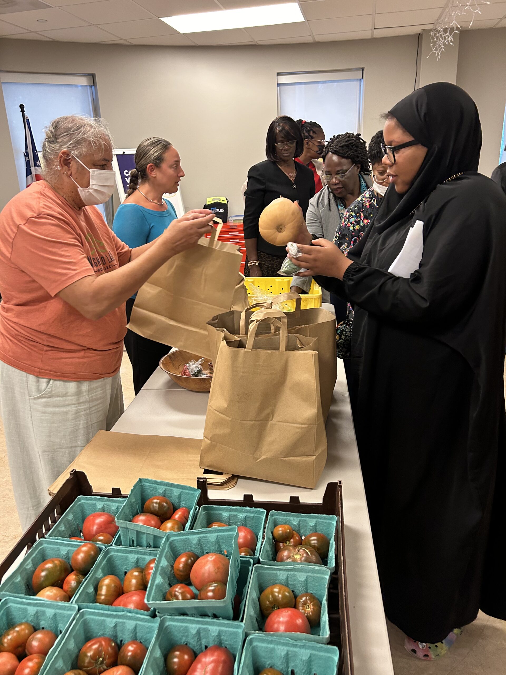 Guests pick up fresh produce at a table
