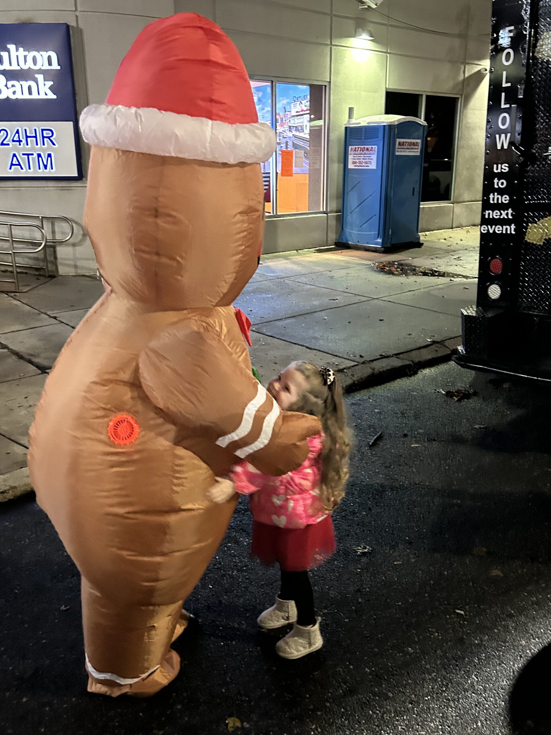 A child meets a giant inflatable gingerbread man
