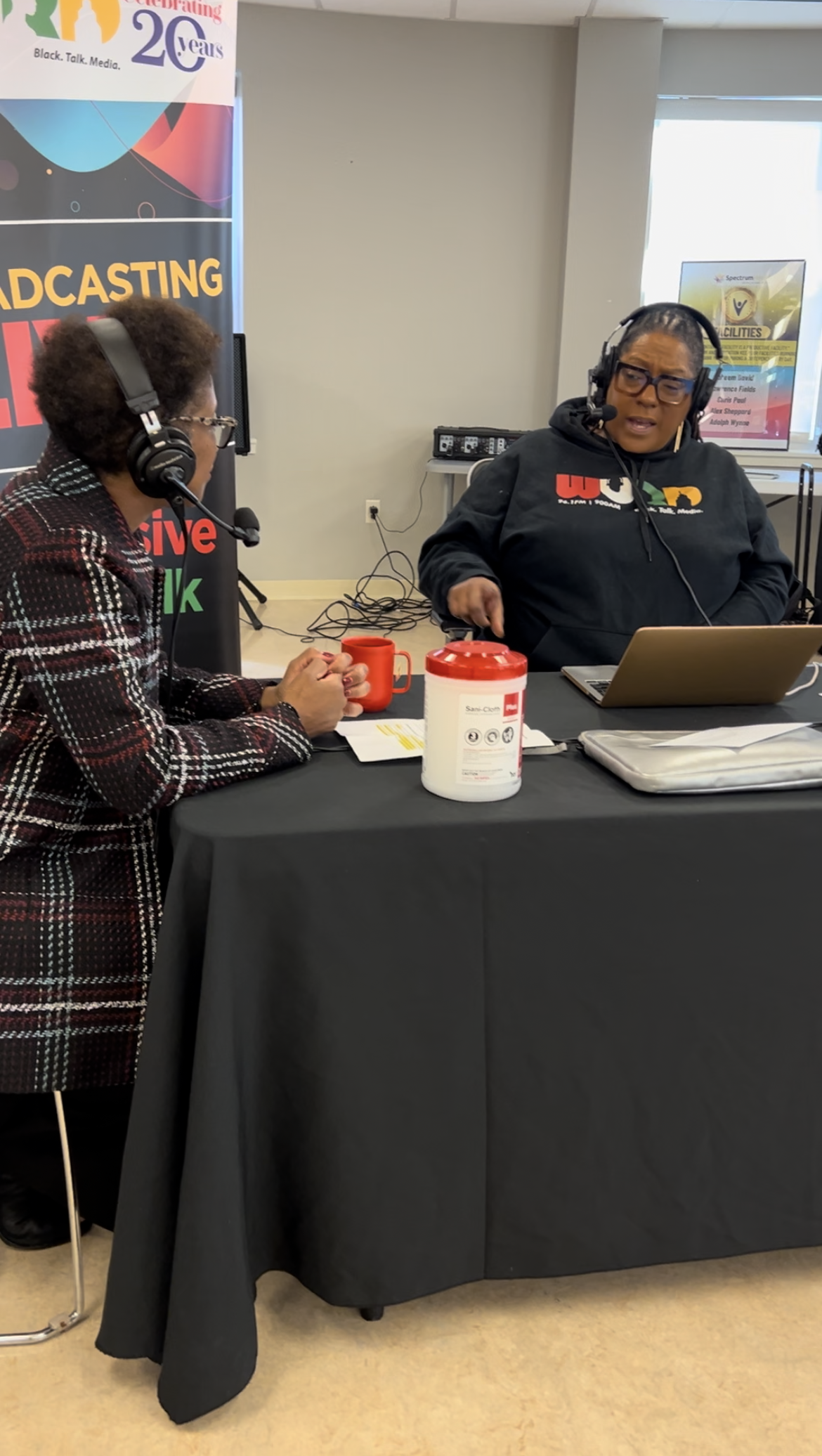 A radio host talks with a guest on air