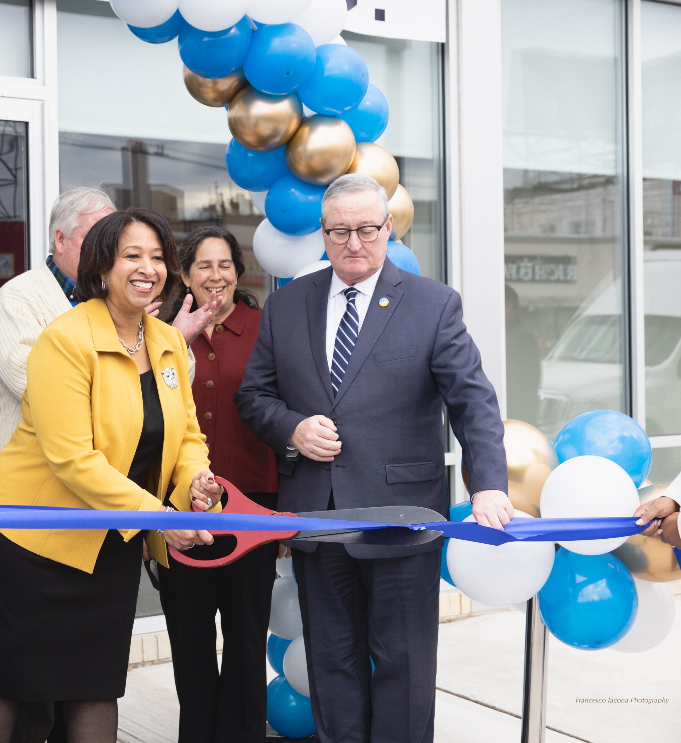 A ribbon cutting with balloons at the Cottman Avenue grand opening