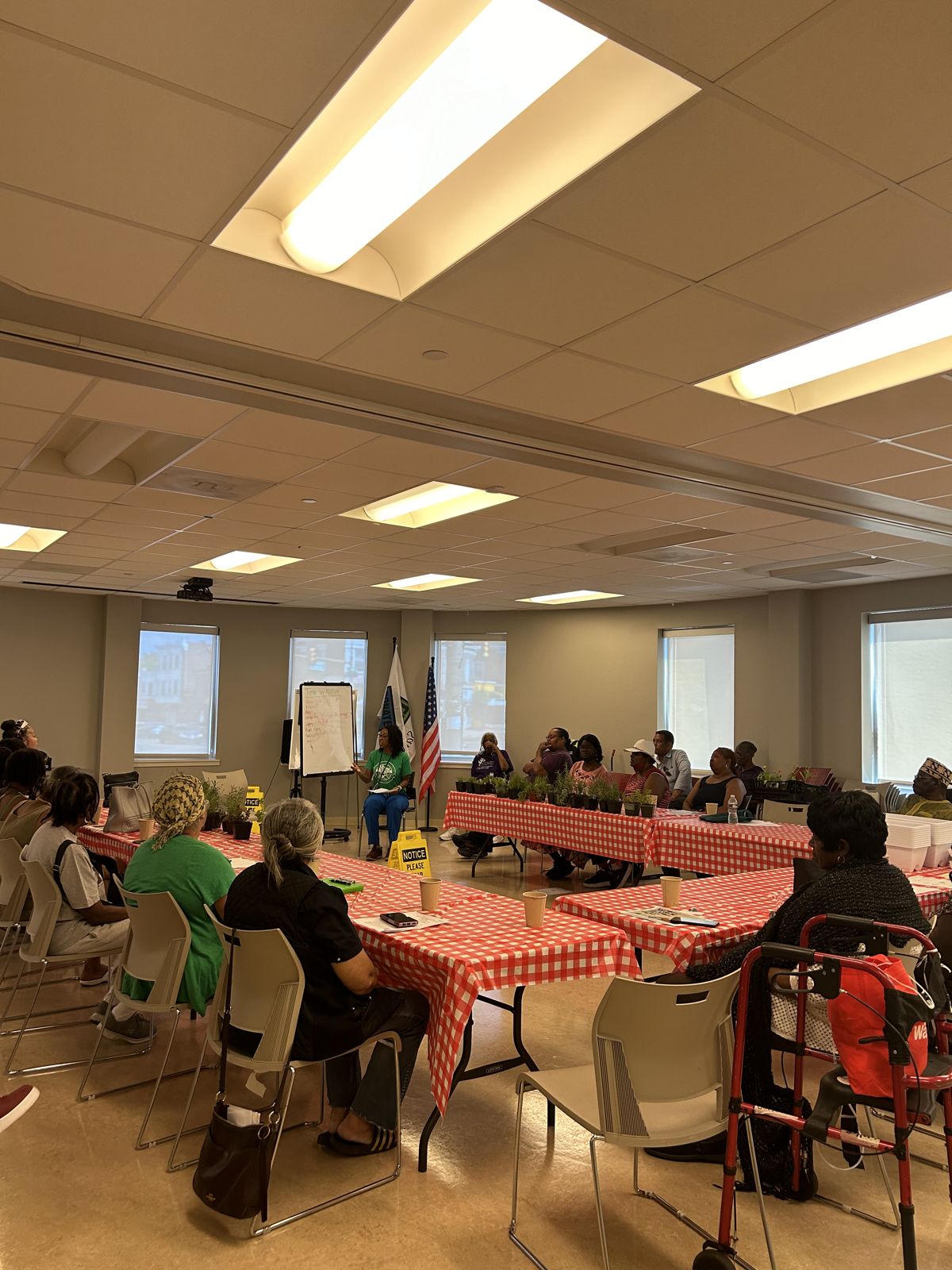 Guests sit at tables during a class