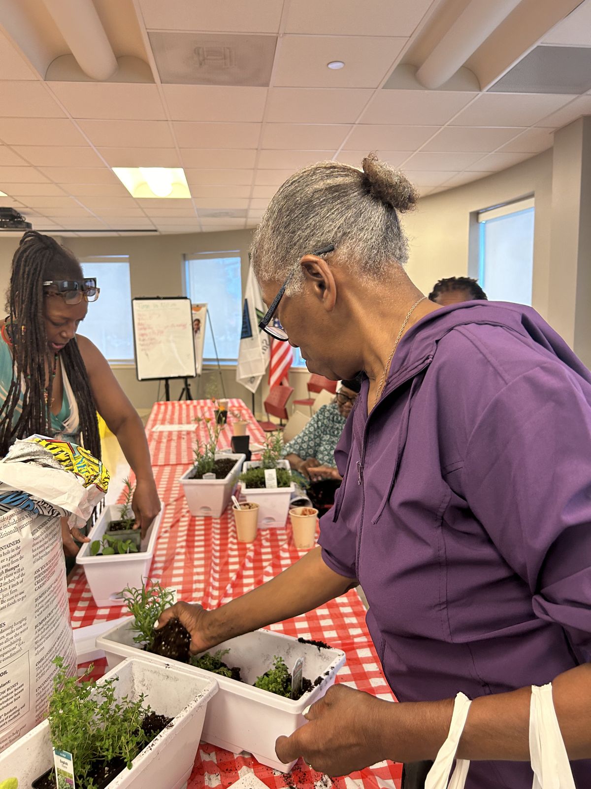 A guest looks at plants during a class on time in nature