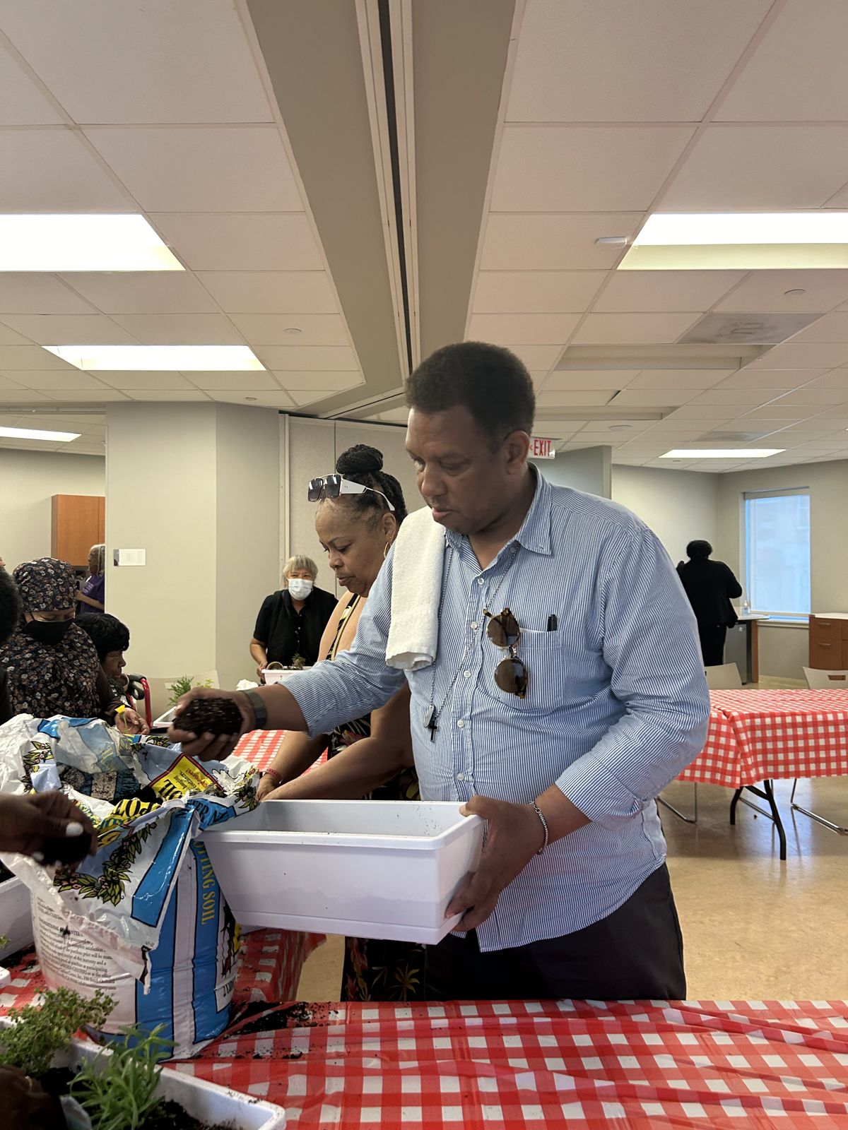 A man unpacks supplies at a class table