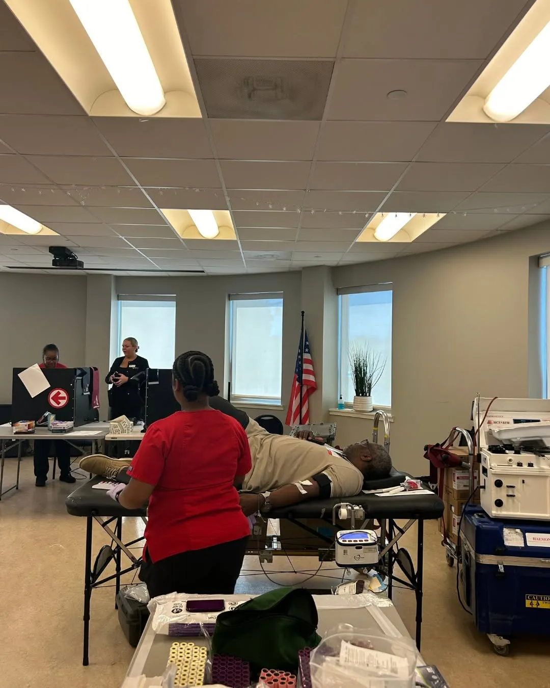 A view of the blood drive room with donors resting and Red Cross workers helping.