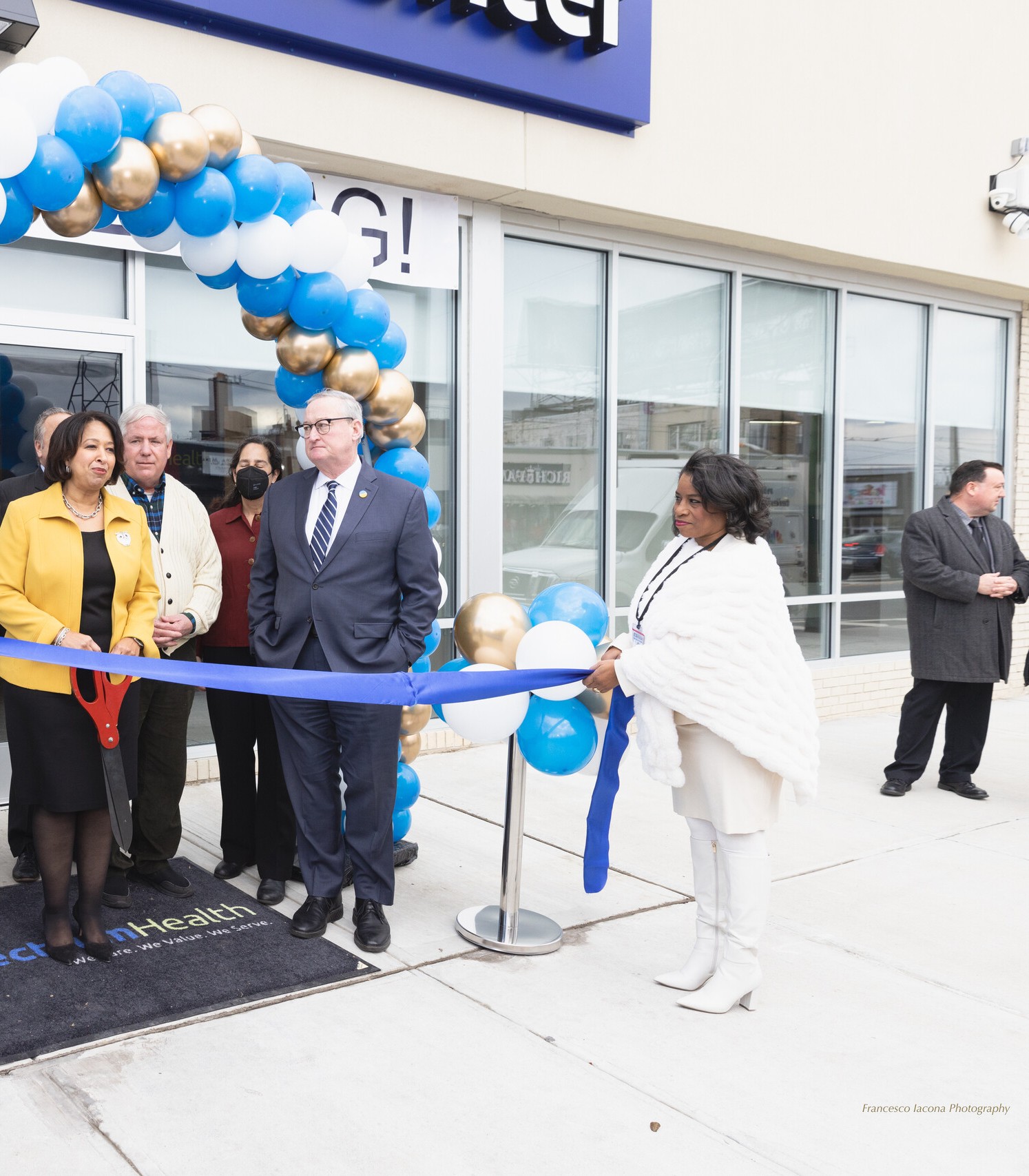 Guests cut the ribbon under a balloon arch at the new Cottman Avenue center