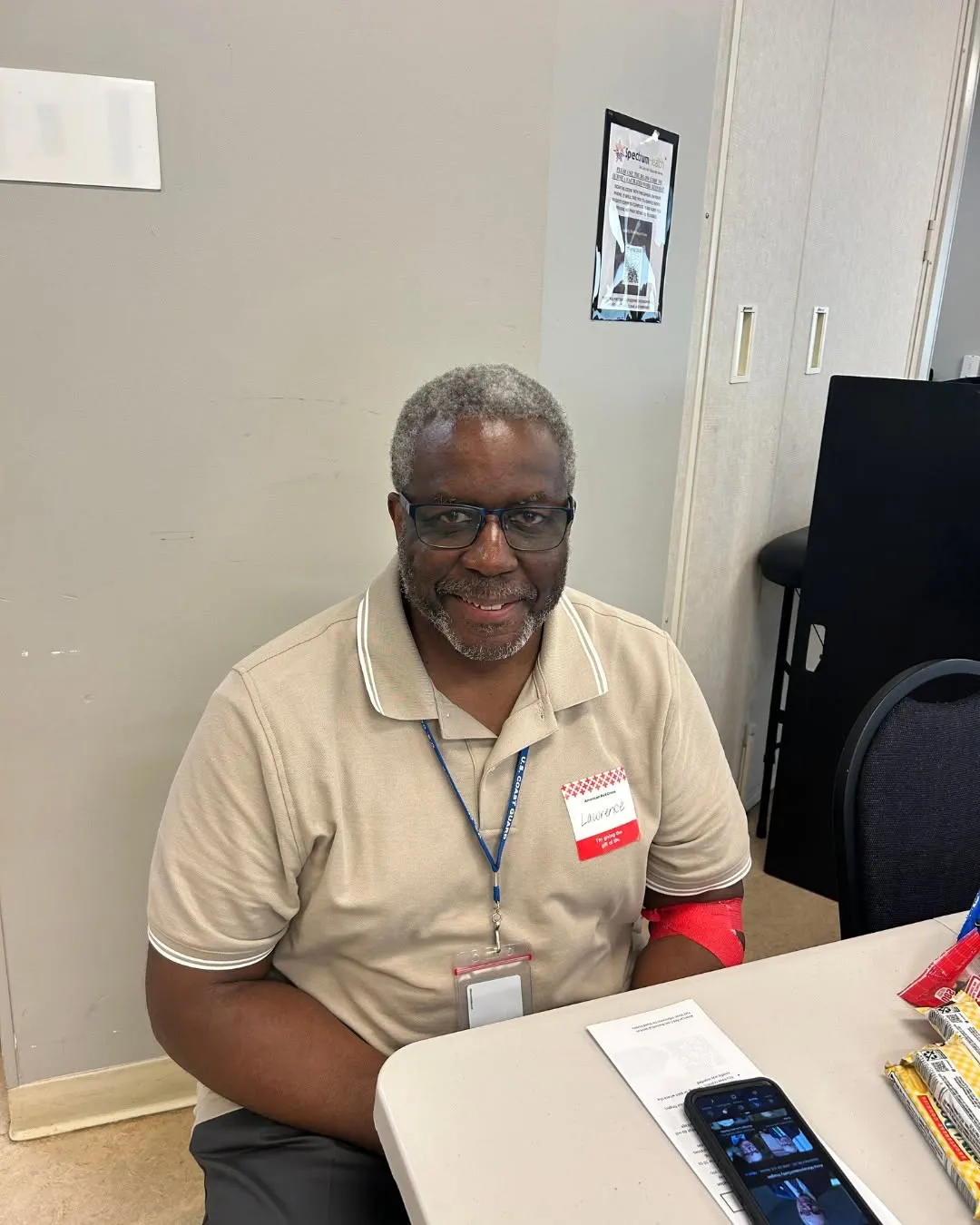 A donor smiles at the table after giving blood.