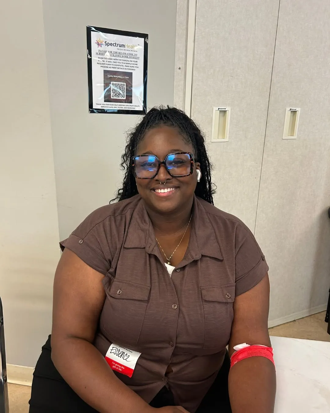 A happy donor sits and smiles after donating blood.