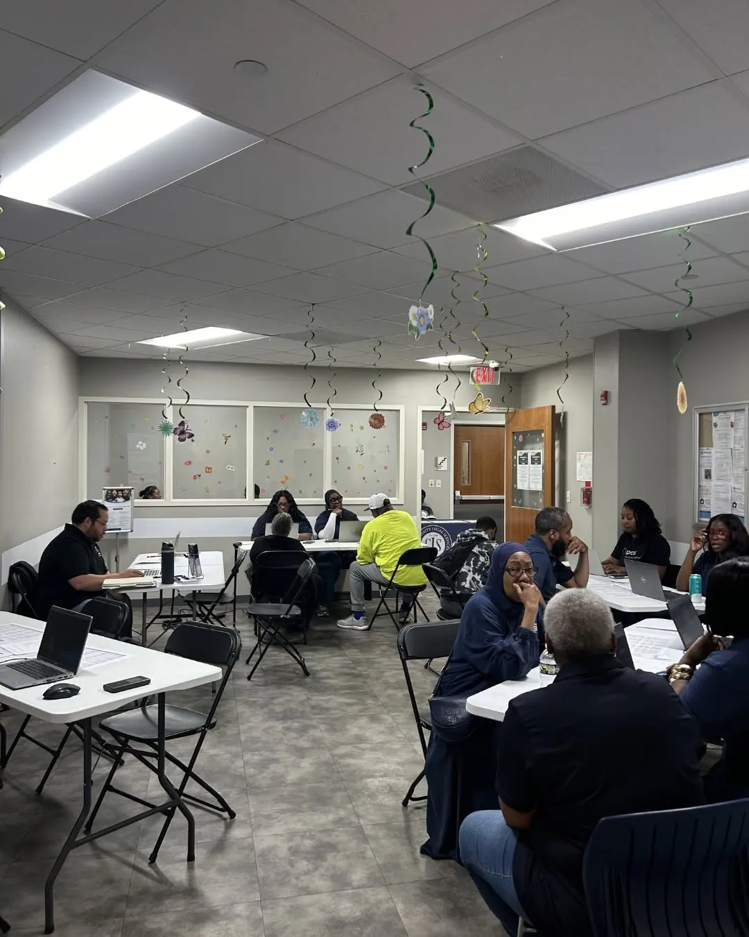 Neighbors sit at tables and get one-on-one help at the resource fair.